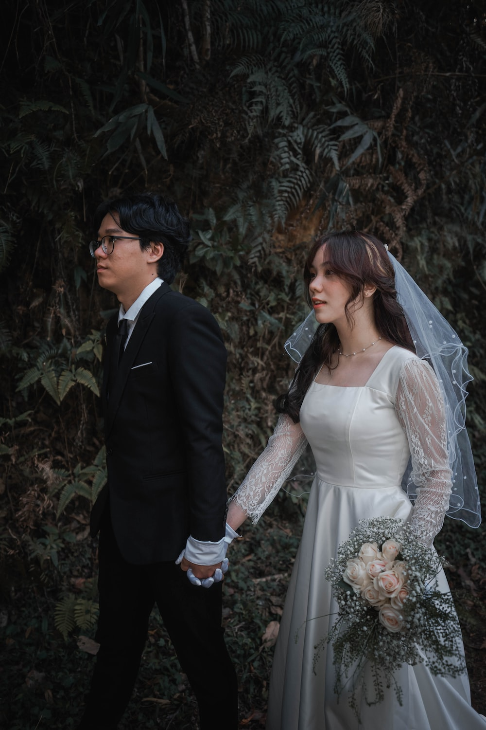 A bride and groom holding hands